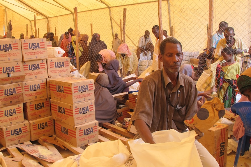 Workers and refugees are seen inside the food distribution centre at Dadaab.