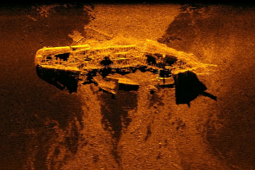A bright orange and brown sonar image of the shipwreck.