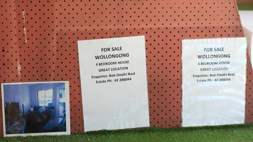  A for sale sign in the window of Bob Onofri's real estate agent on Crown Street Wollongong, 2023