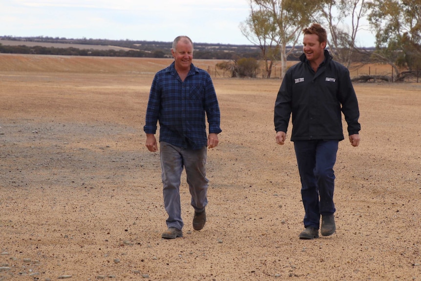 Jeff Munns and his son Dan enjoy a laugh while walking in a paddock on their farm near Beacon.