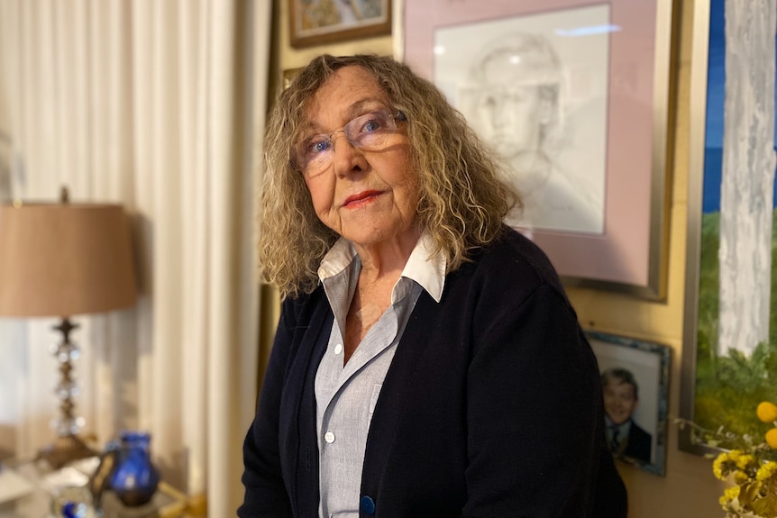 Abuse survivor Beth Heinrich in her home wearing glasses.