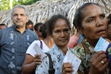 Jose Ramos Horta (L) queues at a polling station to cast his vote in the East Timor presidential election.
