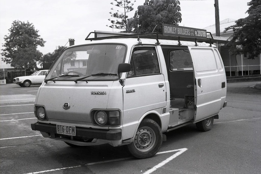 A black and white photo of a Toyota van.