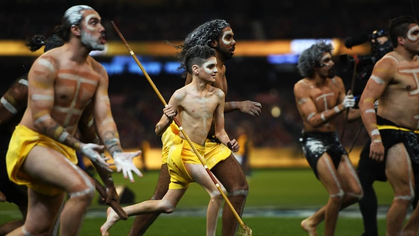 Indigenous dancers celebrate on the field at the MCG, Melbourne.