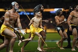 Indigenous dancers celebrate on the field at the MCG, Melbourne.