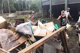 Volunteers cleaning up a property after flooding in Logan
