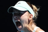 A Polish female tennis player screams out as she celebrates winning a point at Australian Open.