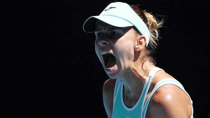 A Polish female tennis player screams out as she celebrates winning a point at Australian Open.