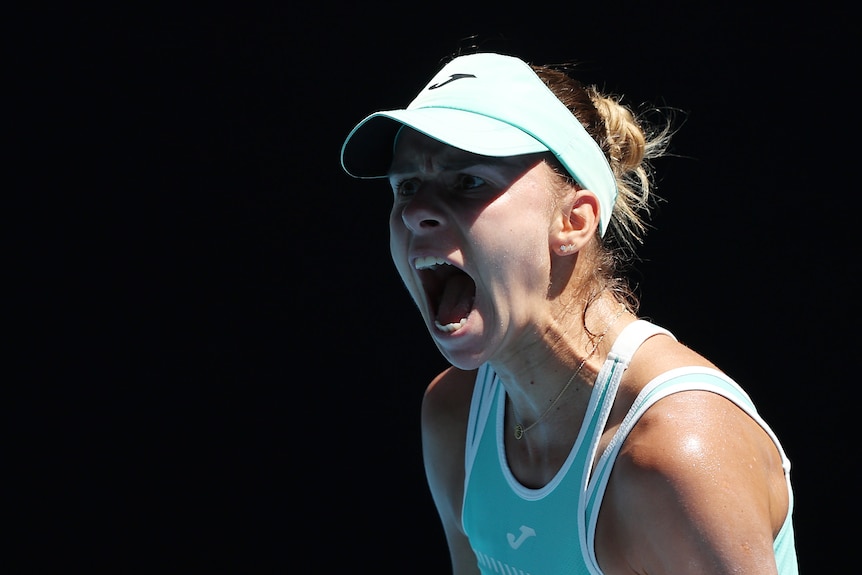 A Polish female tennis player screams out as she celebrates winning a point at Australian Open.