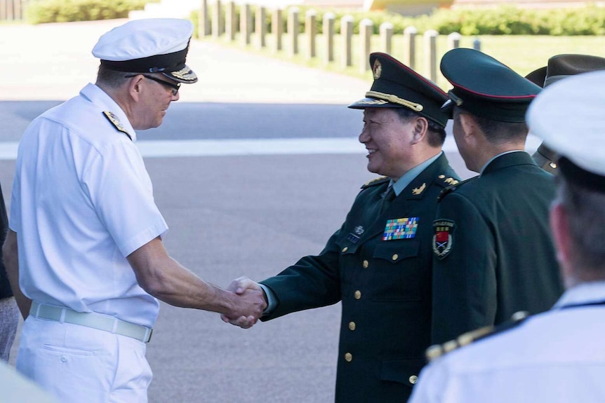 Men in uniform shake hands