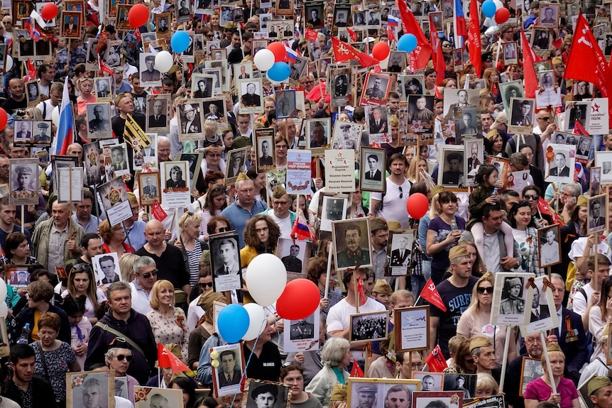 Russians carry portraits of people in Victory Day parade