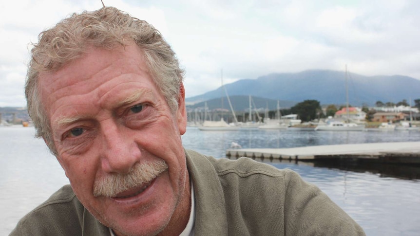 Don Marsh sitting on the side of the Derwent River in Hobart