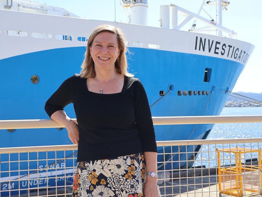 Associate Professor Helen Phillips poses in front of a ship.