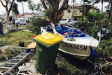 A small speed boat lodged among debris in Kurnell.