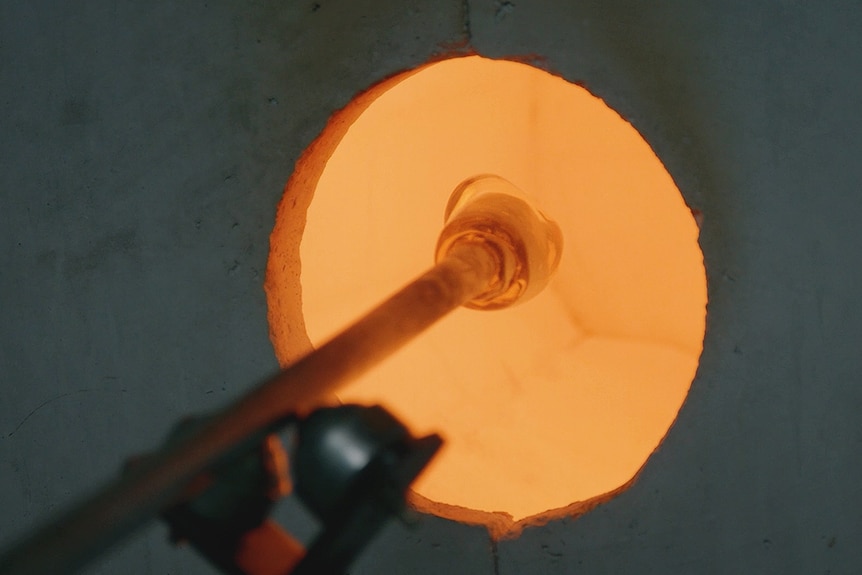 Glass bulb placed into a furnace.