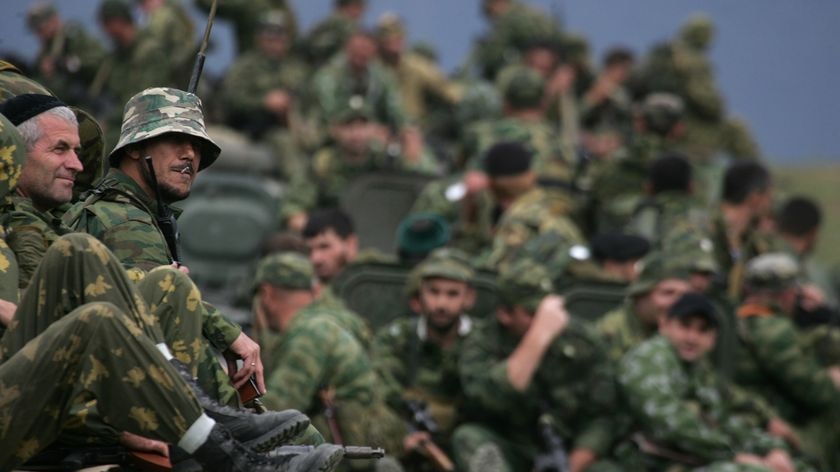 Russian troops sit on armoured personnel carriers in the South Ossetian town of Dzhava