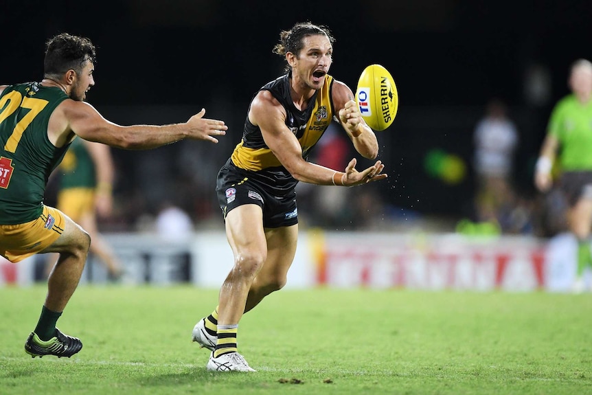 Cam Ilett handpasses during the 2019-20 grand final between Nightcliff and St Mary's.