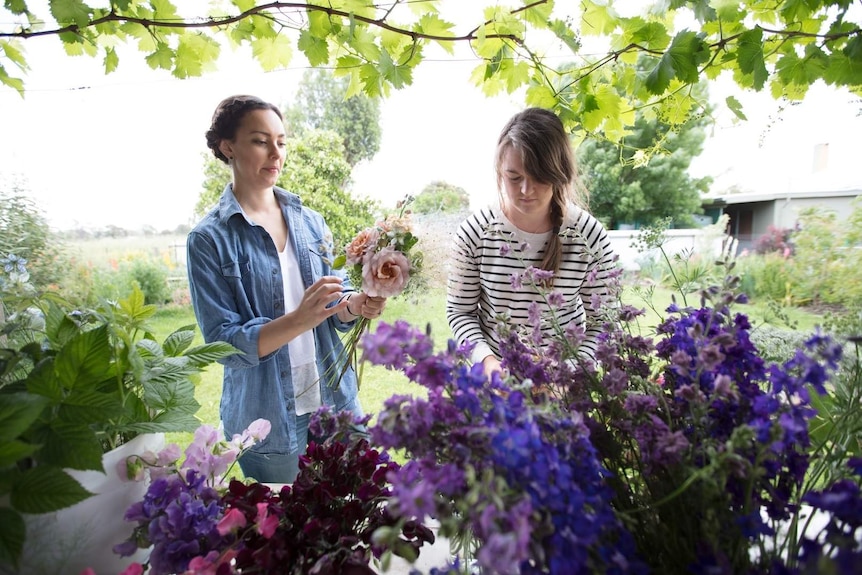 Bethany Saab and Sophie Kurylowicz tend to their garden, they own a successful small business in regional Australia