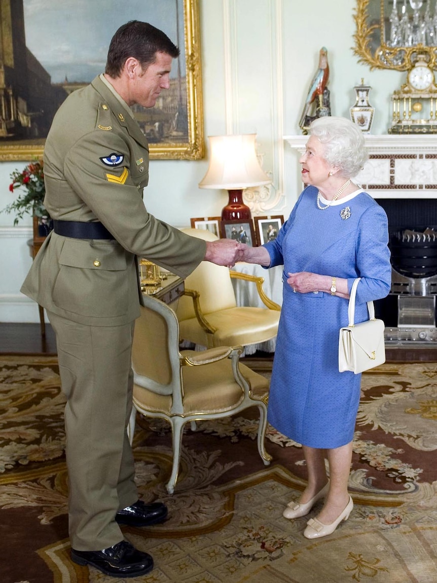 Queen Elizabeth II greets Corporal Ben Roberts-Smith during an audience at Buckingham Palace.