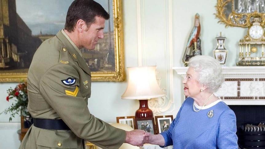 Queen Elizabeth II greets Corporal Ben Roberts-Smith during an audience at Buckingham Palace.
