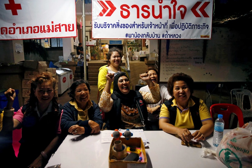 Volunteers cheer as the boys are released