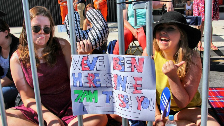 Two girls waiting to spot the royal couple at South Bank