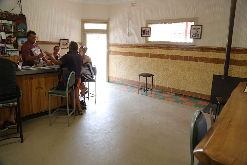 Customers sit at the bar across from the wall where Bowie had stood.