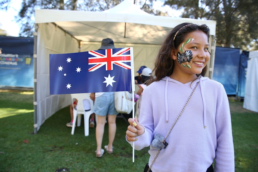 A girl holding an Australian flag