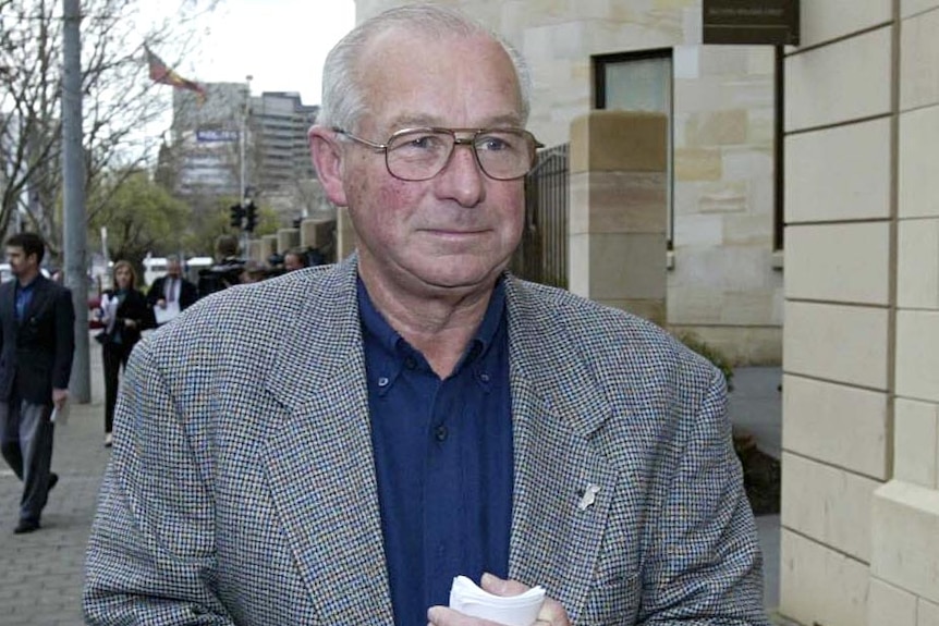Former NSW detective Roger Rogerson leaves the Magistrate's Court in Adelaide.