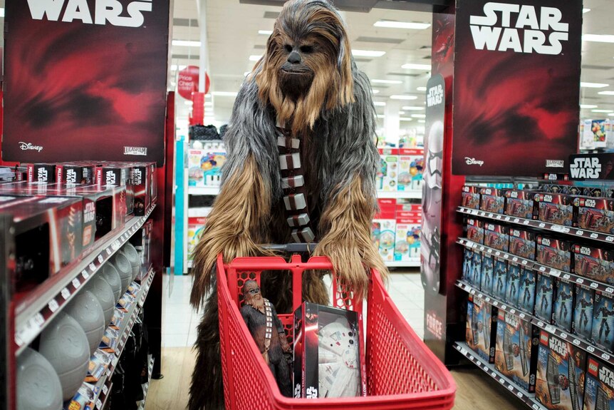 A fan dressed as Chewbacca shops for merchandise from the upcoming film 'Star Wars: The Force Awakens' movie