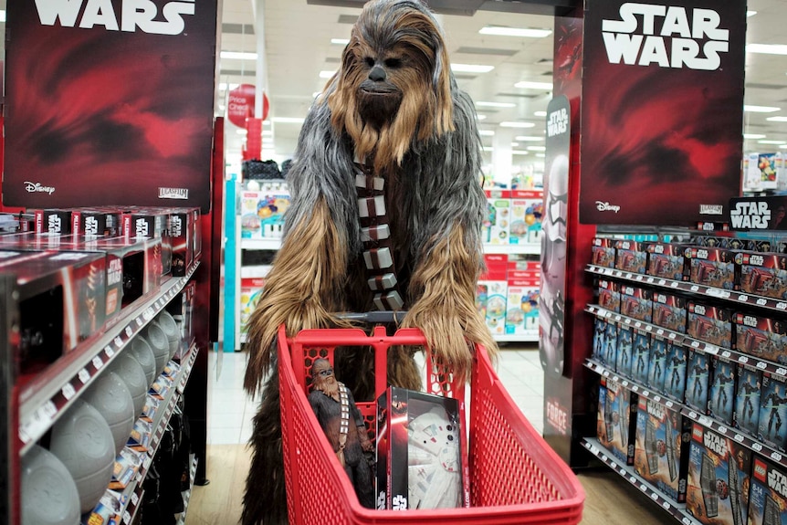 A fan dressed as Chewbacca shops for merchandise from the upcoming film 'Star Wars: The Force Awakens' movie