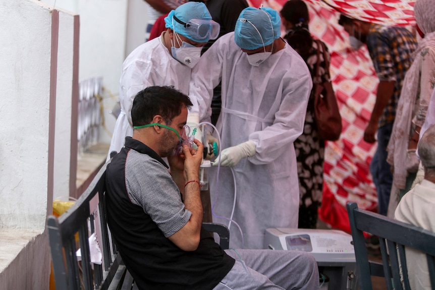 Indian man receiving oxygen