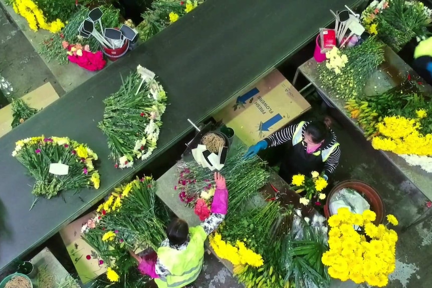 An aerial view of workers making bouquets in a Lynch Group warehouse.