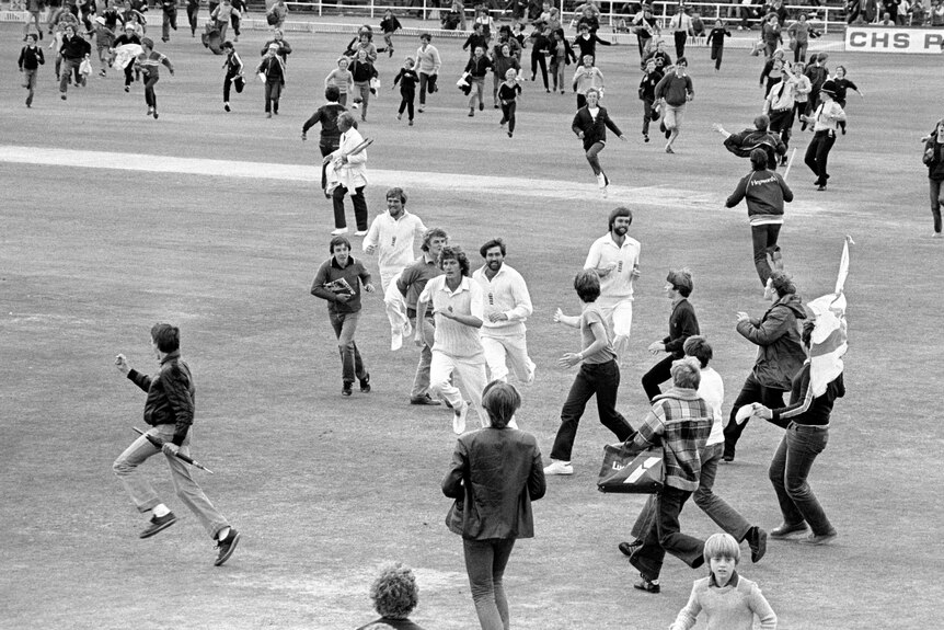 Bob Willis and England players run off the field as fans swarm onto the grass at Headingley in 1981.
