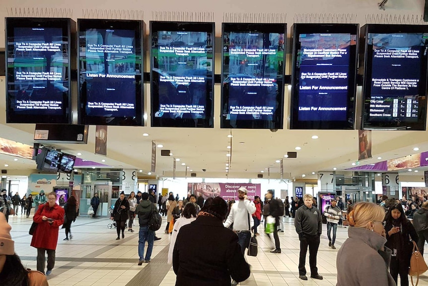 Screens at Flinders Street station show all trains lines suspended after a computer fault