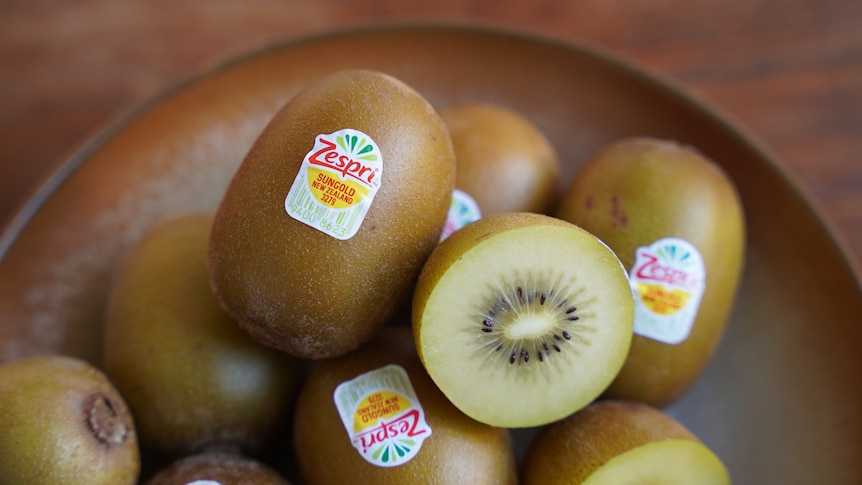 A plate of gold kiwifruits with the Zespri label visible. 
