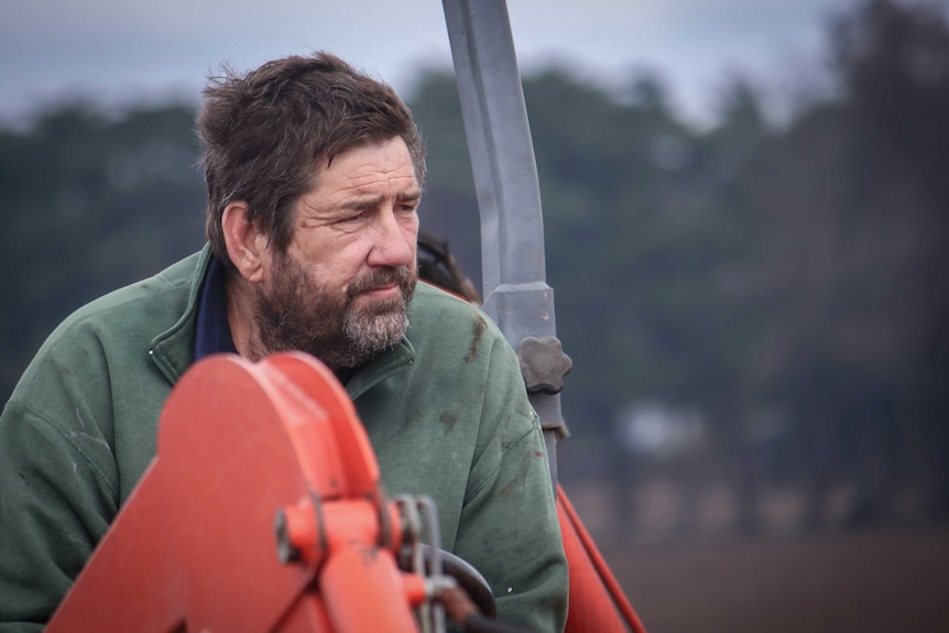 A wearing looking farmer.