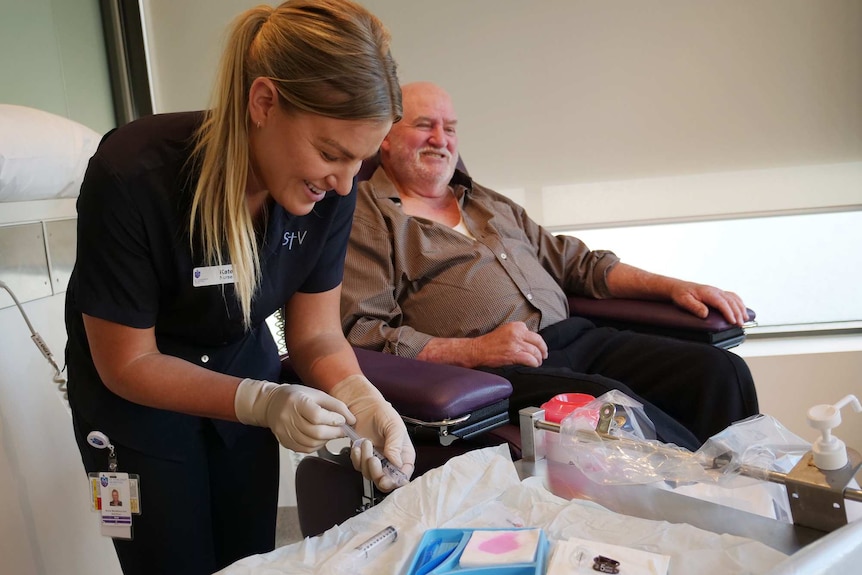 Nurse Kate Chirnside prepares a needle to be used on a blood test