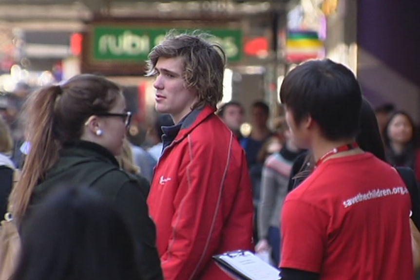 Charity representatives speak to people on the street