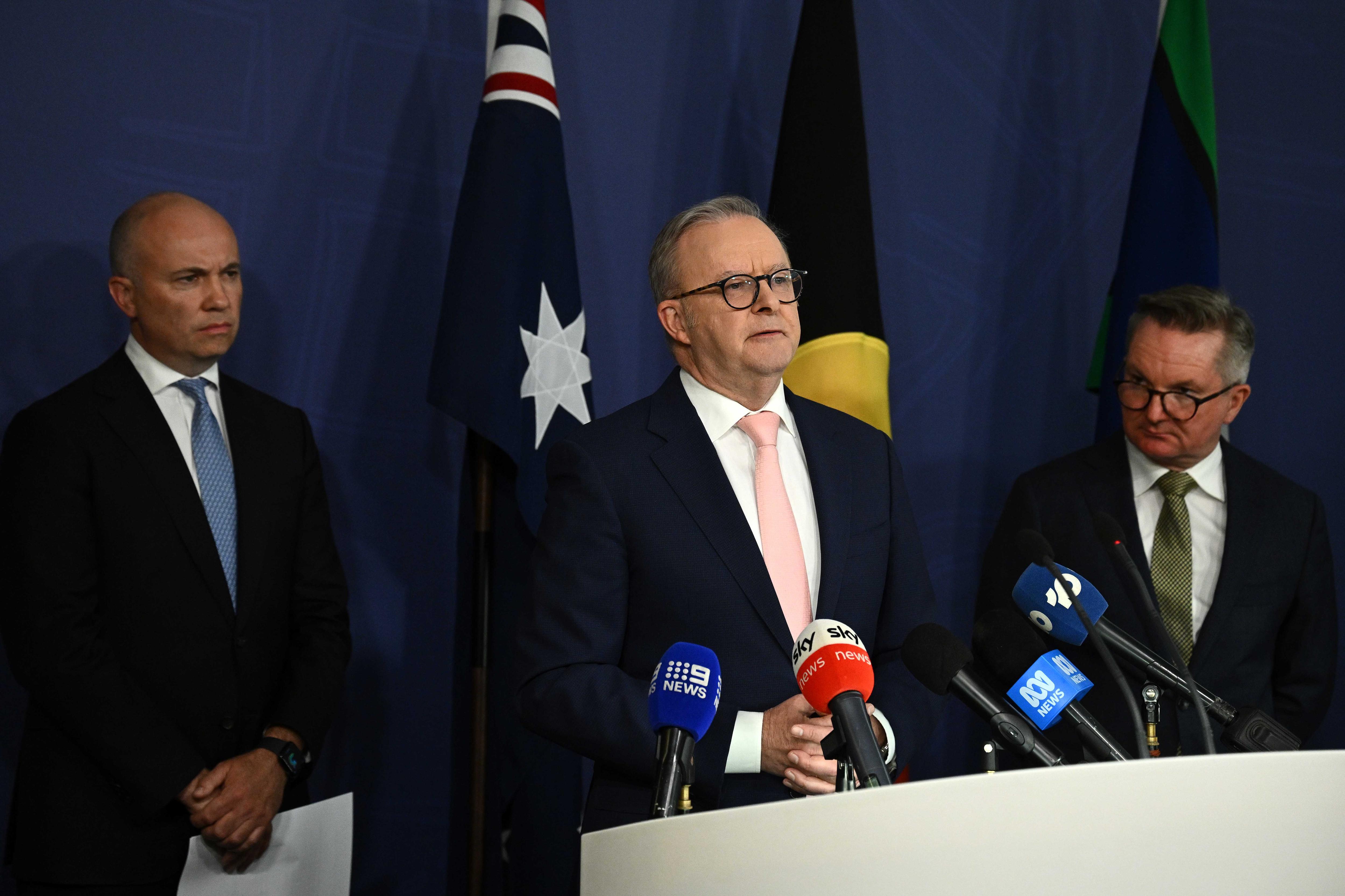 Matt Kean, Anthony Albanese and Chris Bowen behind a lecturn. 