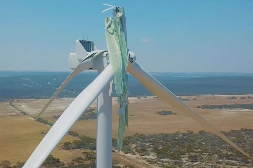 A wind turbine with one blade melted.