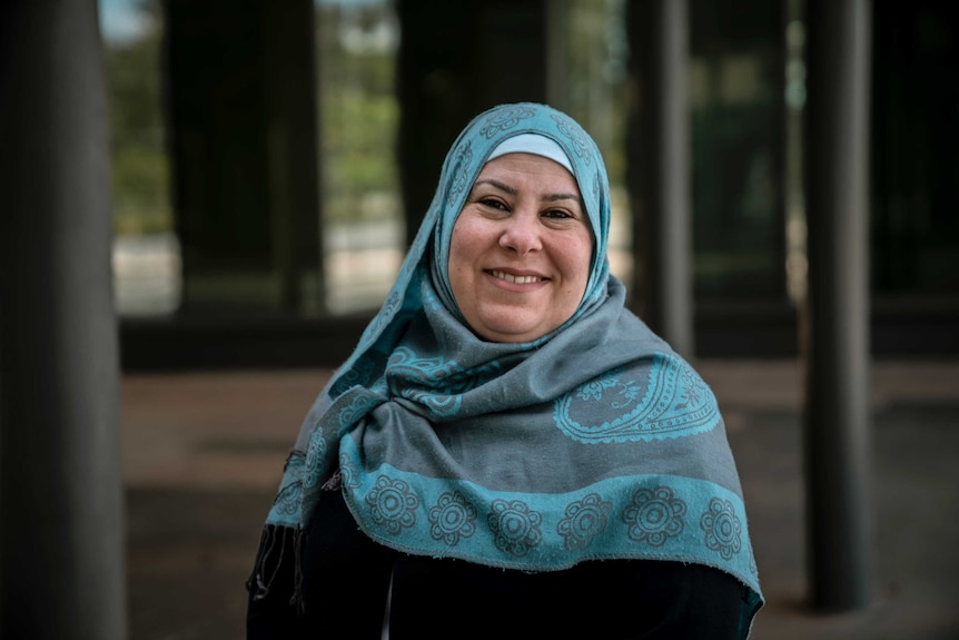 Dr Fida Sanjakdar wearing blue hijab and smiling.