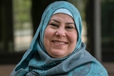 Fida Sanjakdar wearing blue hijab and smiling.
