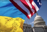 A ukraine flag and us flag in front of the capitol building. 