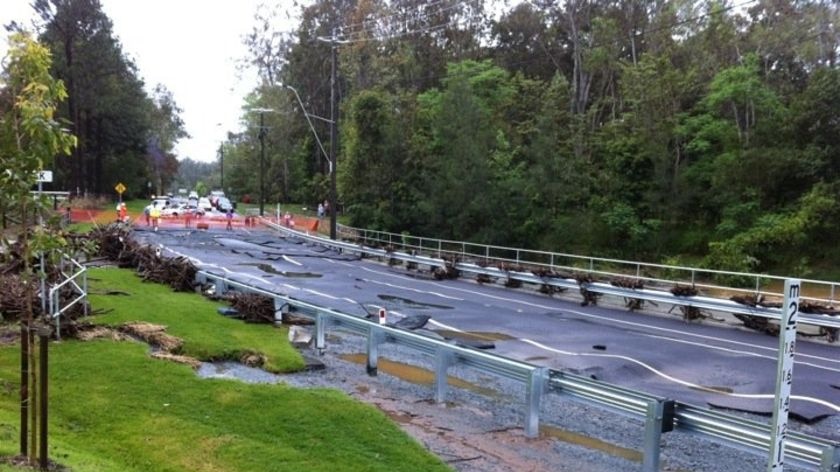 Rafting Ground Road in Brookfield, in Brisbane's west, lies in shreds after the recent heavy flooding.