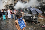 Iraqis check the scene of a car bomb attack in the mostly Shiite neighbourhood of Baghdad Jadida in Baghdad.