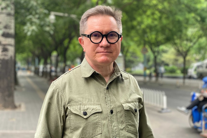 New York Times reporter Chris Buckley standing on a street in Beijing