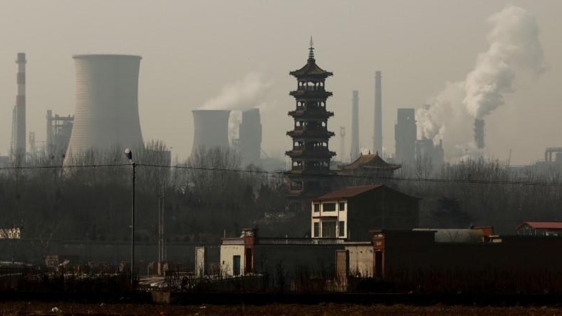 Cooling towers emit steam and chimneys billow in an industrial zone in Wu'an, Hebei province, China