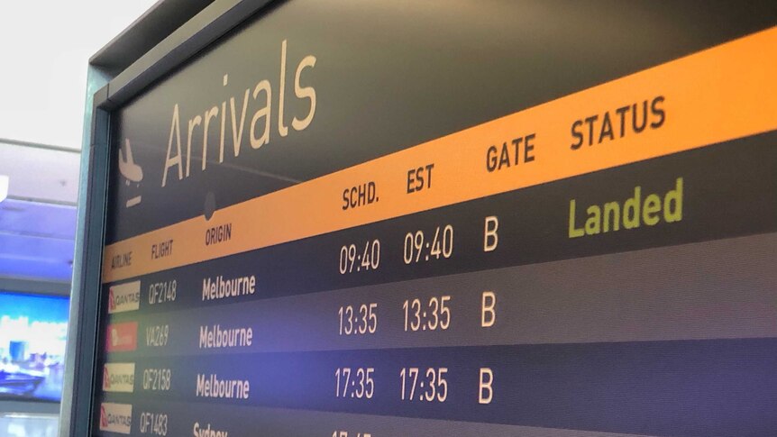 A flight arrivals screen showing Melbourne flights at Canberra Airport.