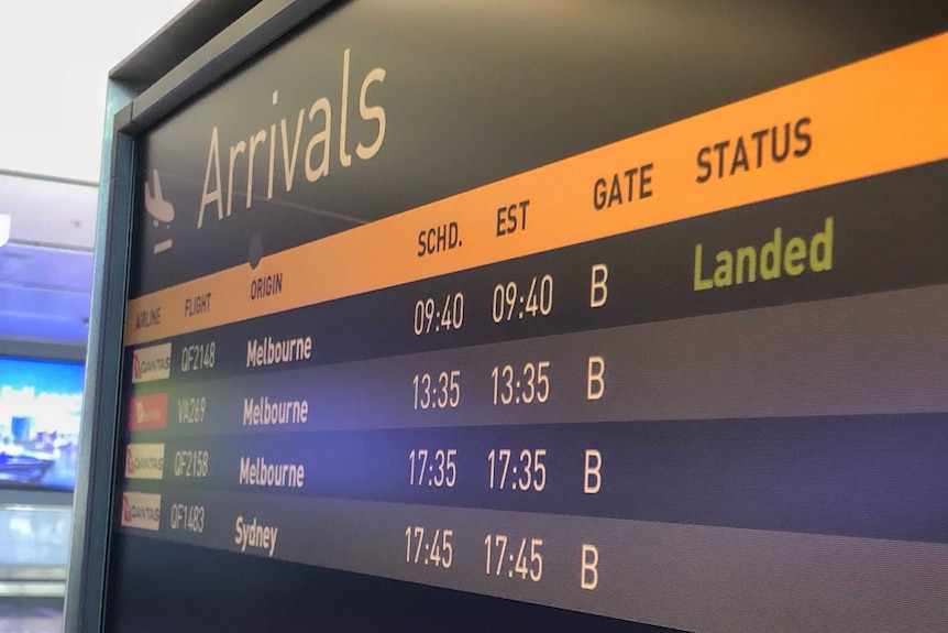 A flight arrivals screen showing Melbourne flights at Canberra Airport.